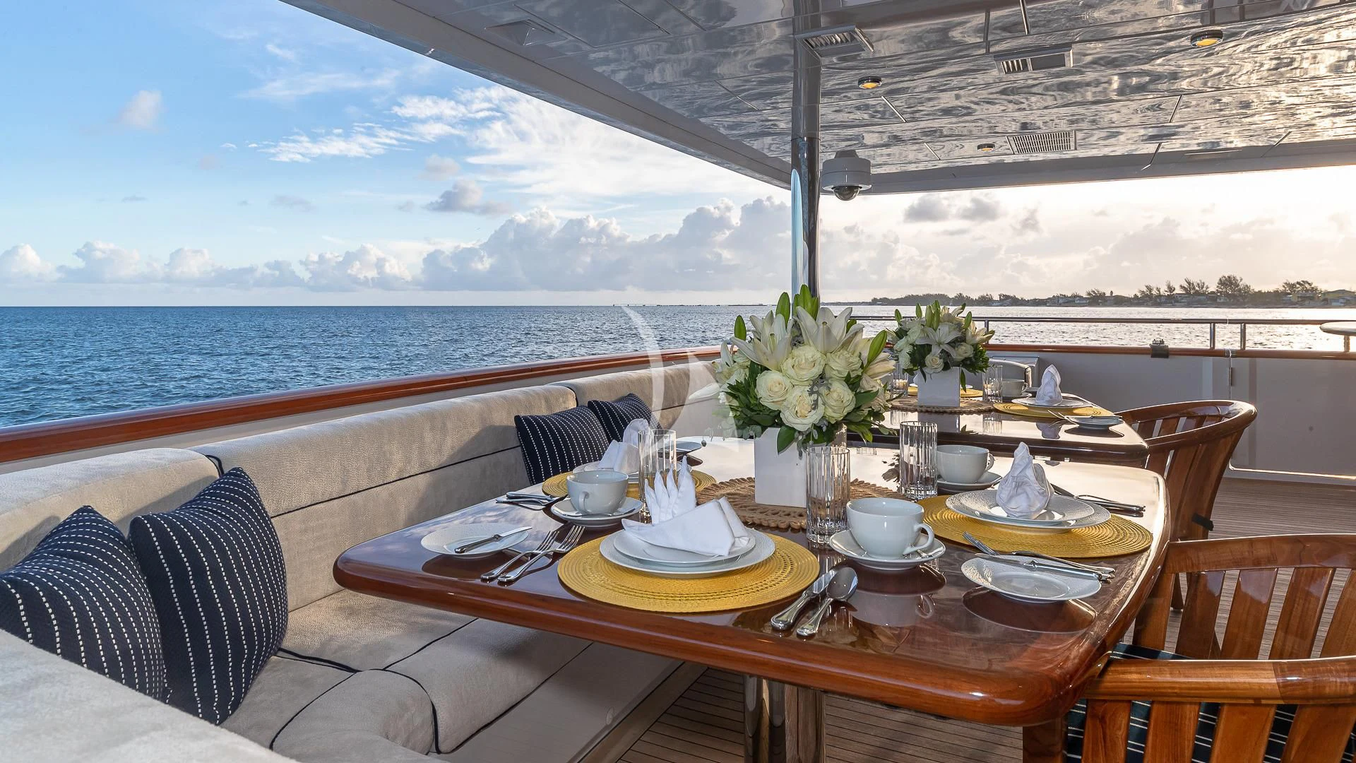 a table with plates and cups on it aboard LADY ELAINE Yacht for Charter