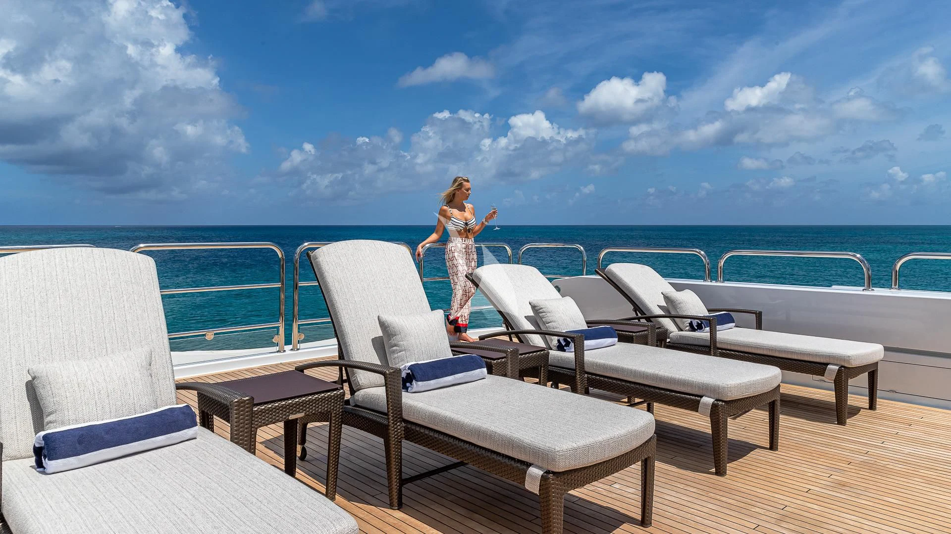 a person standing on a deck overlooking the ocean aboard LADY ELAINE Yacht for Charter
