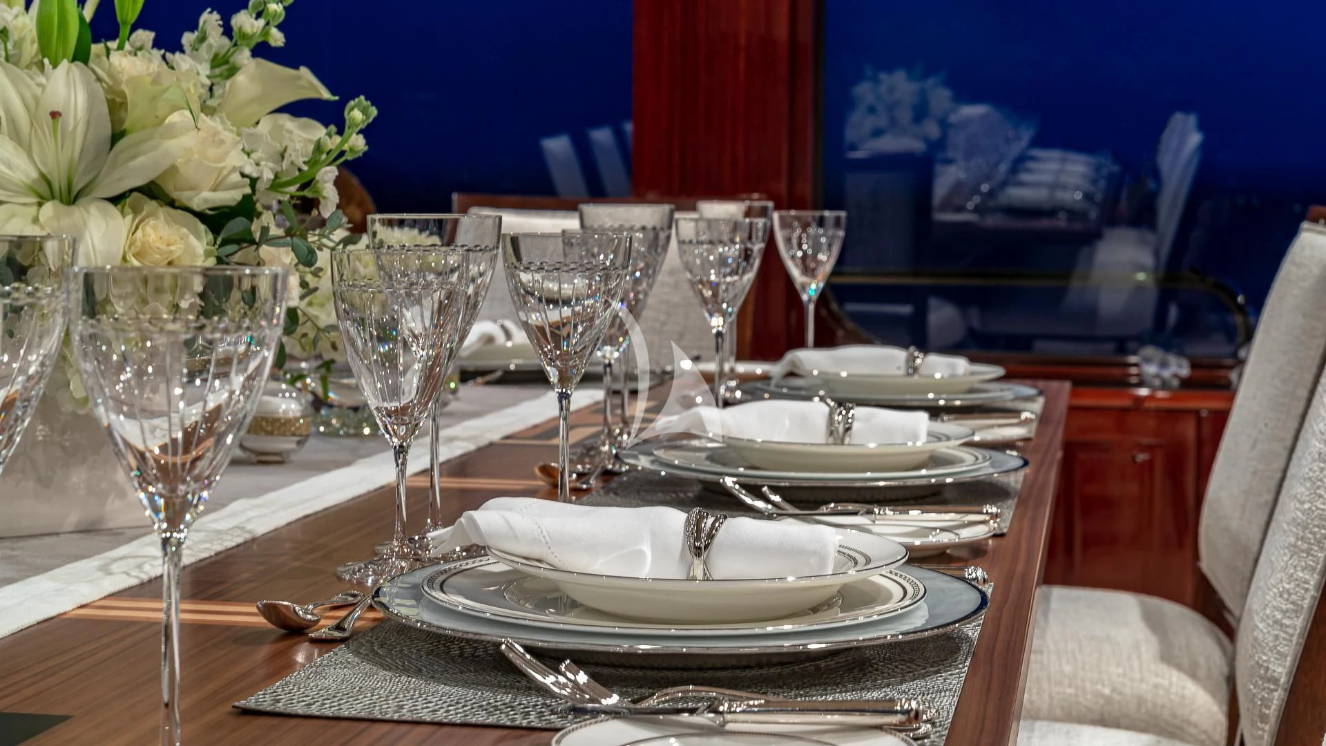 a table set with plates and glasses aboard LADY ELAINE Yacht for Charter