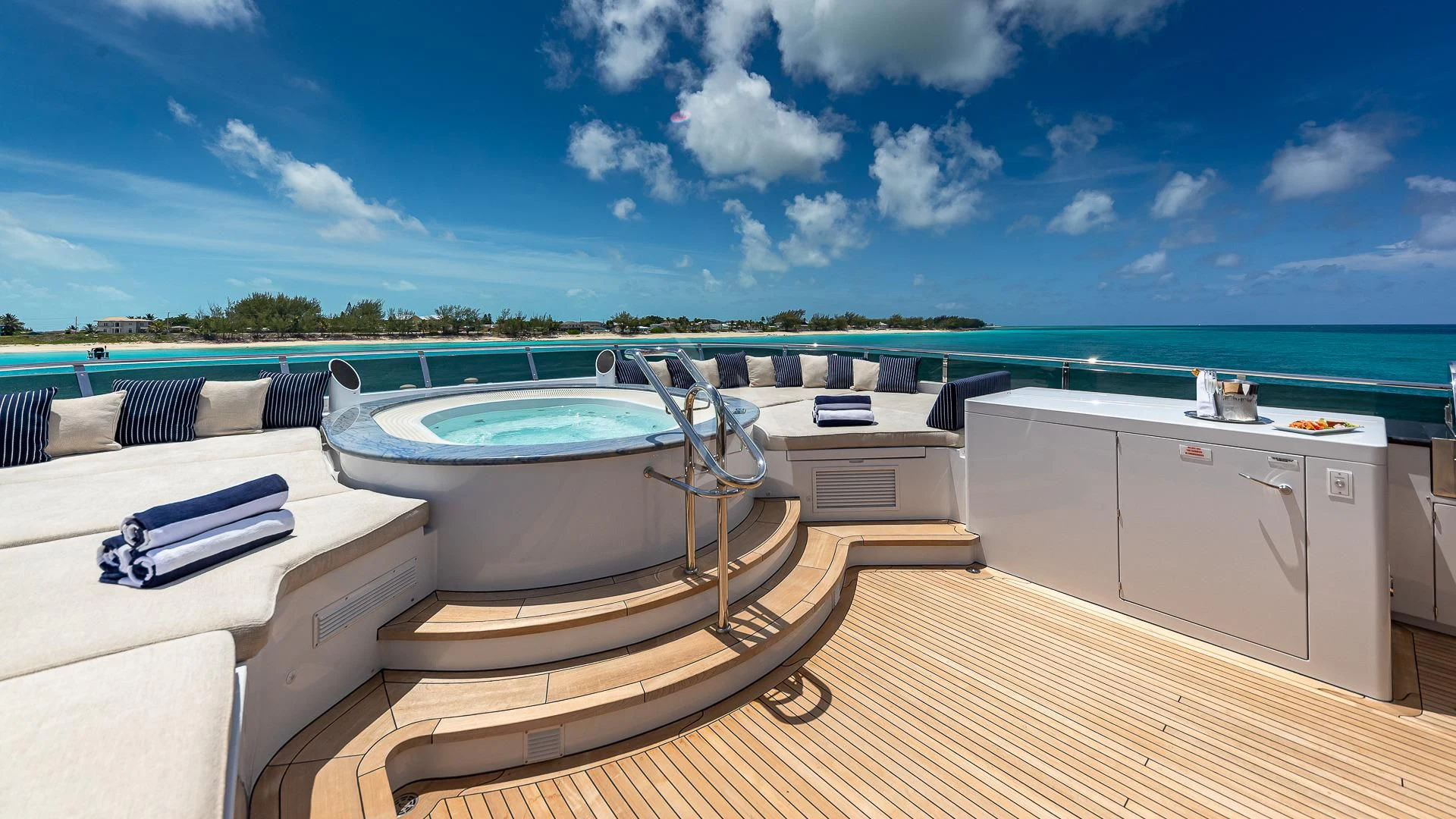 a large pool with a deck and a deck and a view of the water aboard LADY ELAINE Yacht for Charter