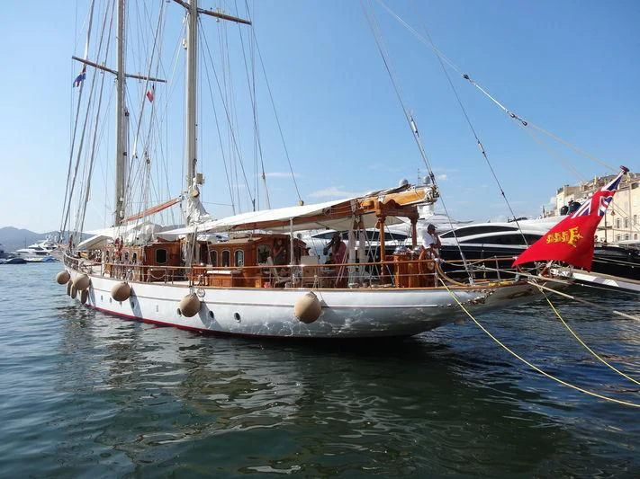 a boat with a red and white flag on it aboard SAKARA Yacht for Sale
