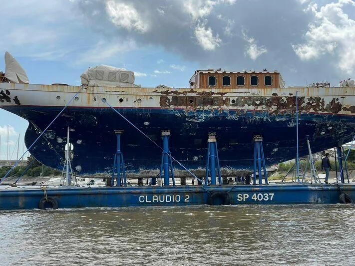 a large blue boat in the water aboard SAKARA Yacht for Sale