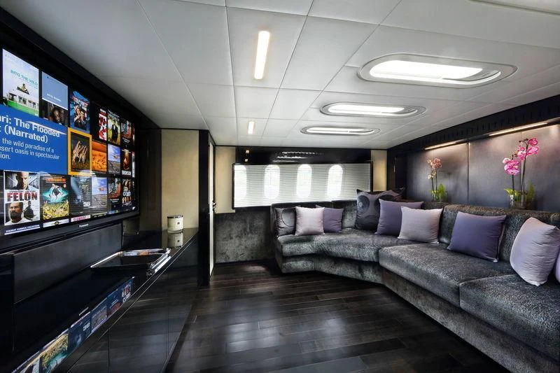 a living room with a large screen aboard PRIMERO Yacht for Sale