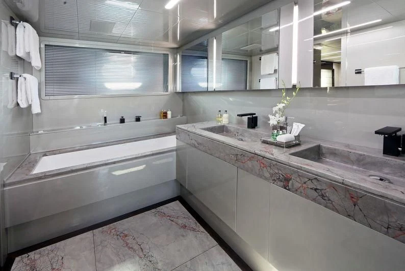 a bathroom with a countertop sink and a mirror aboard PRIMERO Yacht for Sale