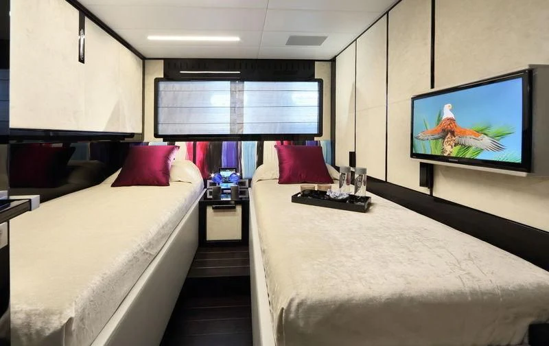 a hotel room with a bed and tv aboard PRIMERO Yacht for Sale