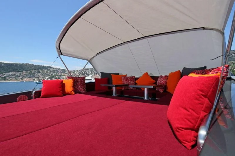 a bed with a red sheet aboard PRIMERO Yacht for Sale