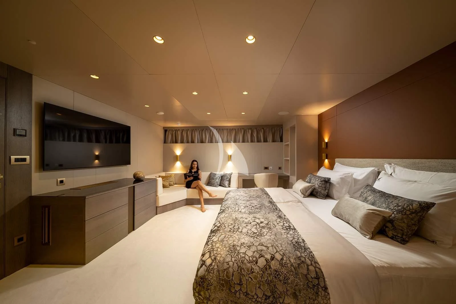 a person sitting on a bed aboard NOCTURNO Yacht for Sale