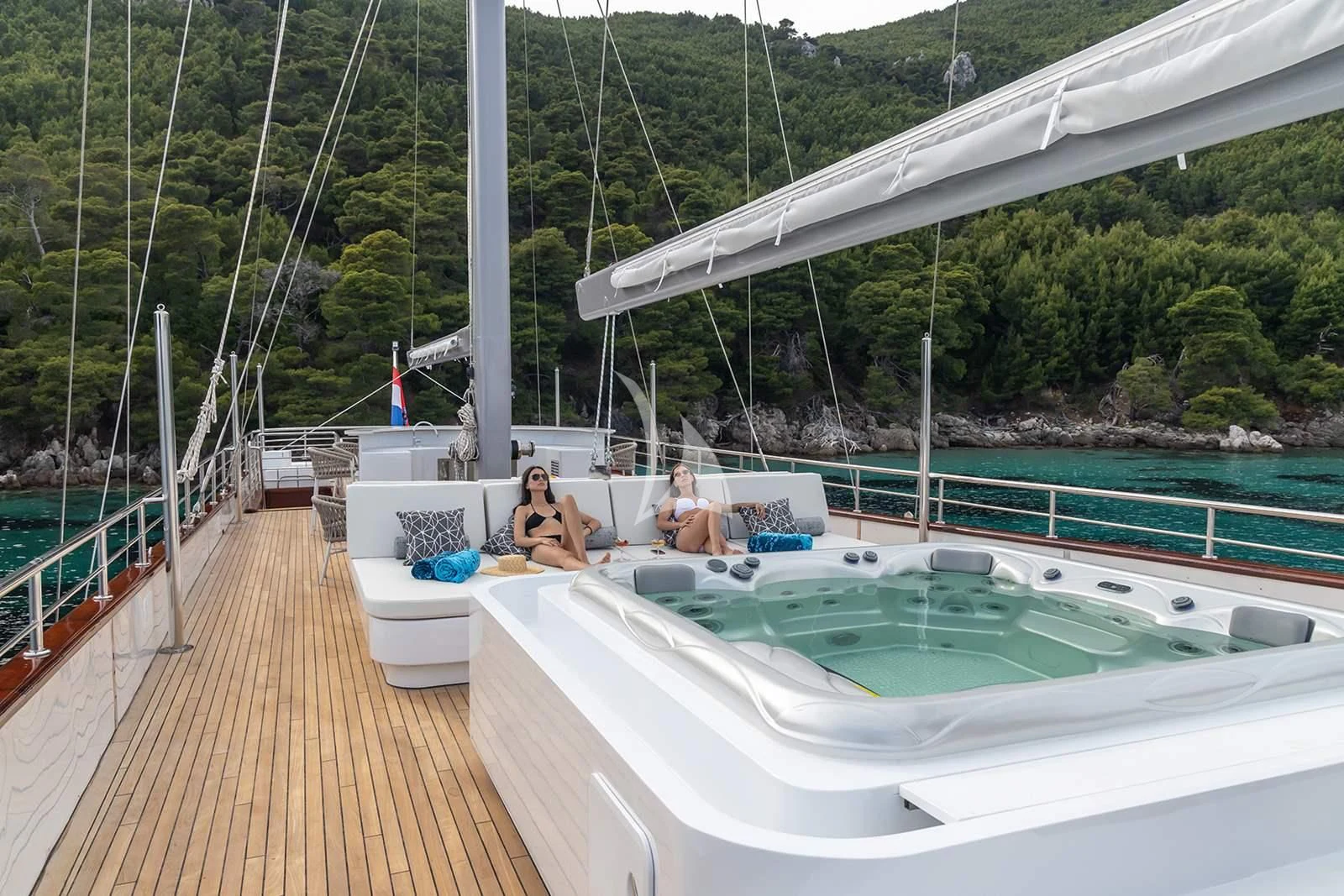 people sitting on a deck of a boat aboard NOCTURNO Yacht for Sale