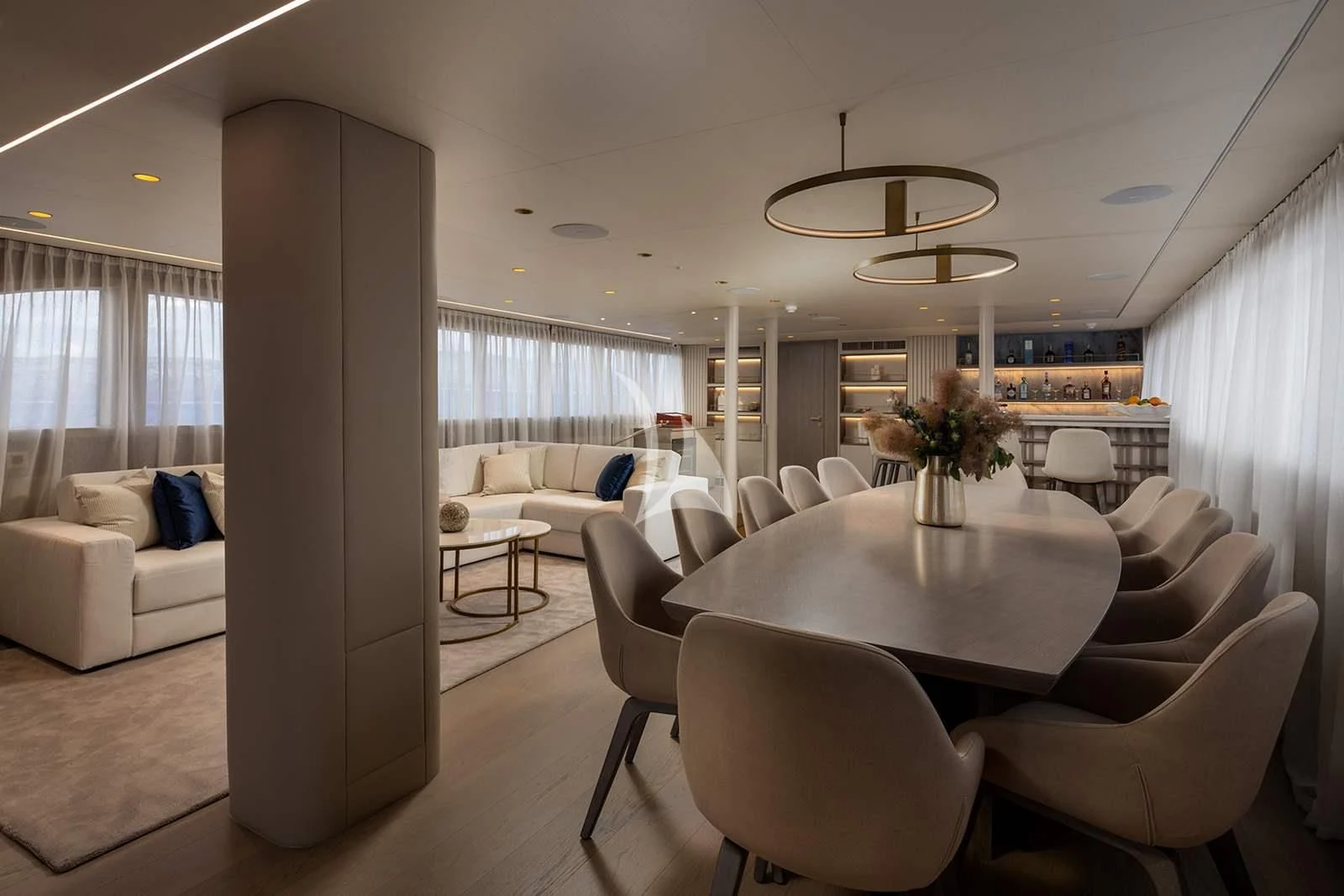 a large living room with a table and chairs aboard NOCTURNO Yacht for Sale