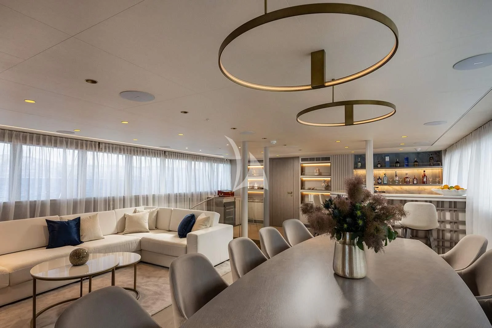 a living room with a large mirror aboard NOCTURNO Yacht for Sale