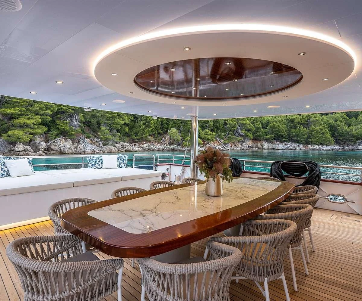 a table and chairs on a deck aboard NOCTURNO Yacht for Sale
