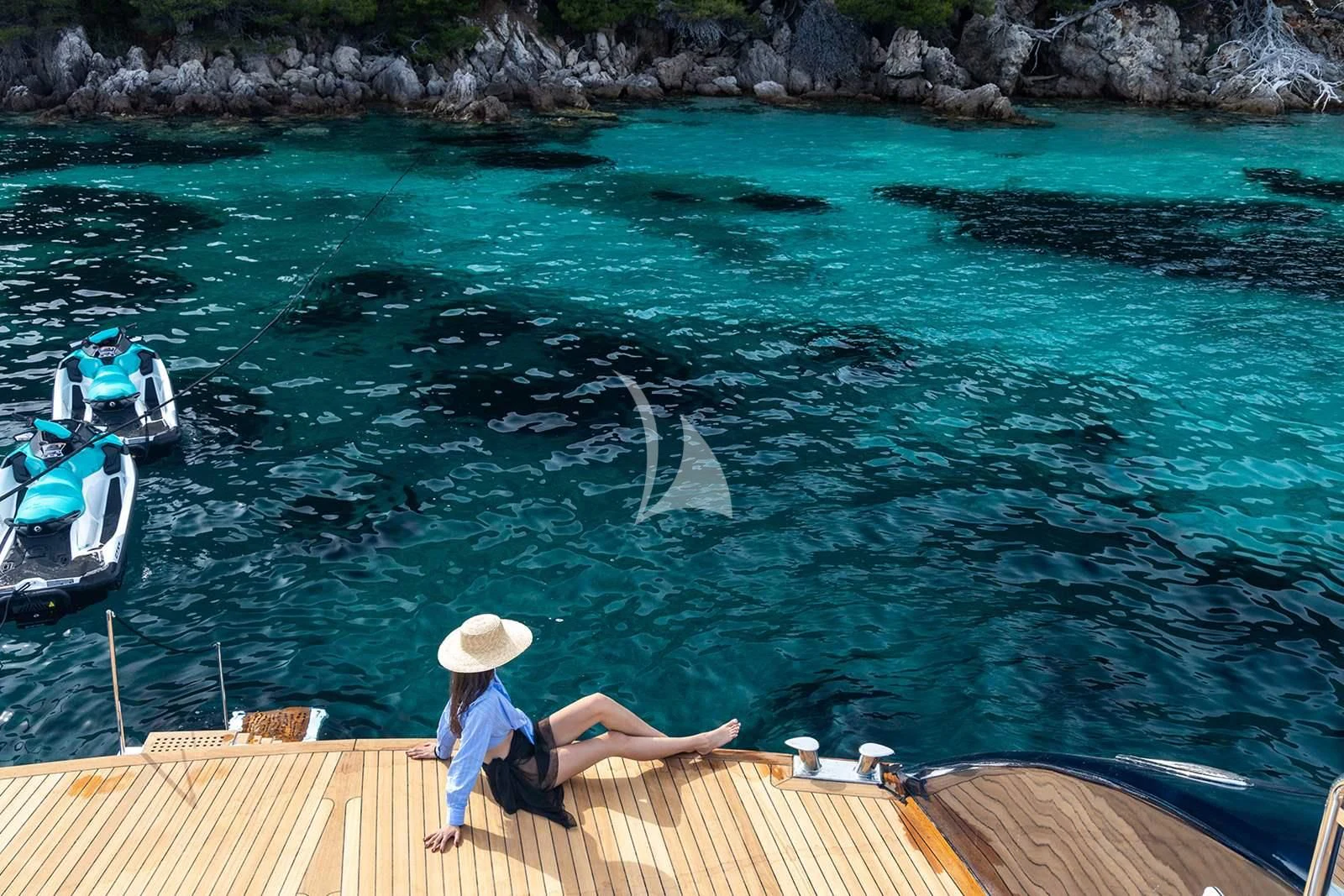 a person on a boat looking at a large fish in the water aboard NOCTURNO Yacht for Sale