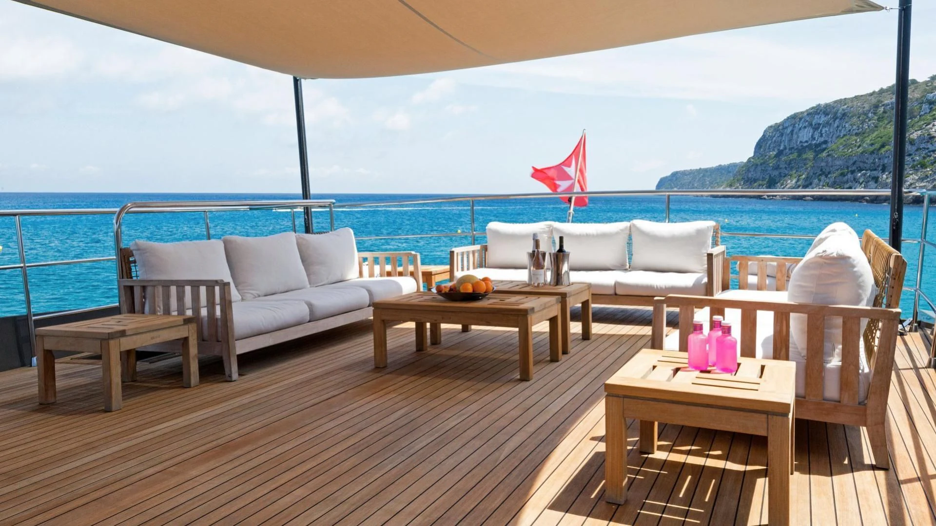 a deck with a table and chairs aboard KOKONUT'S WALLY Yacht for Sale