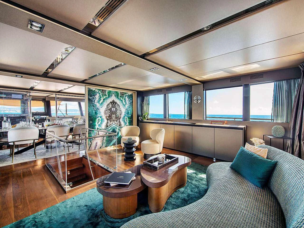 a living room with a large window aboard KOKONUT'S WALLY Yacht for Sale