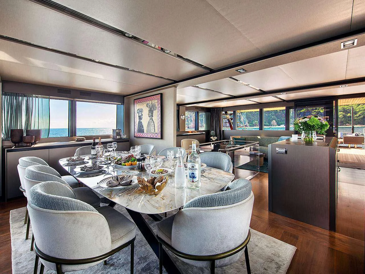 a large dining table in a room aboard KOKONUT'S WALLY Yacht for Sale