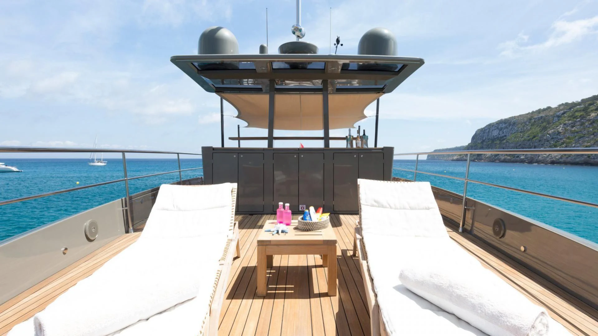 a deck with a large grill and a body of water aboard KOKONUT'S WALLY Yacht for Sale