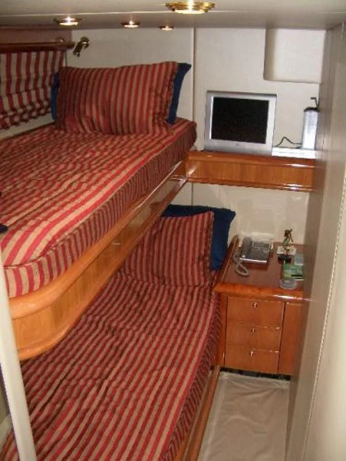 a bedroom with a bed and a desk aboard H2 Yacht for Sale