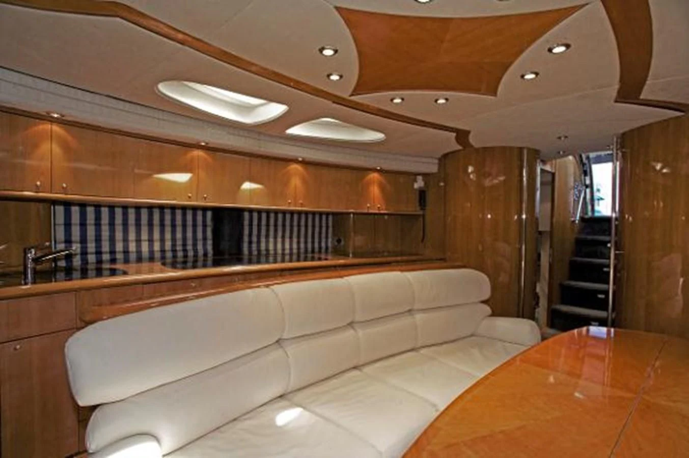 a room with a couch and a table aboard H2 Yacht for Sale