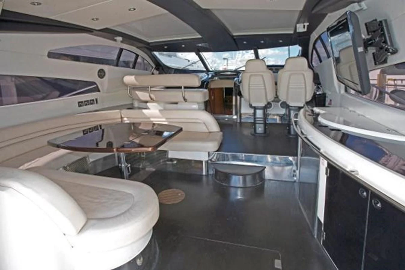 a room with many seats and a plane in it aboard H2 Yacht for Sale
