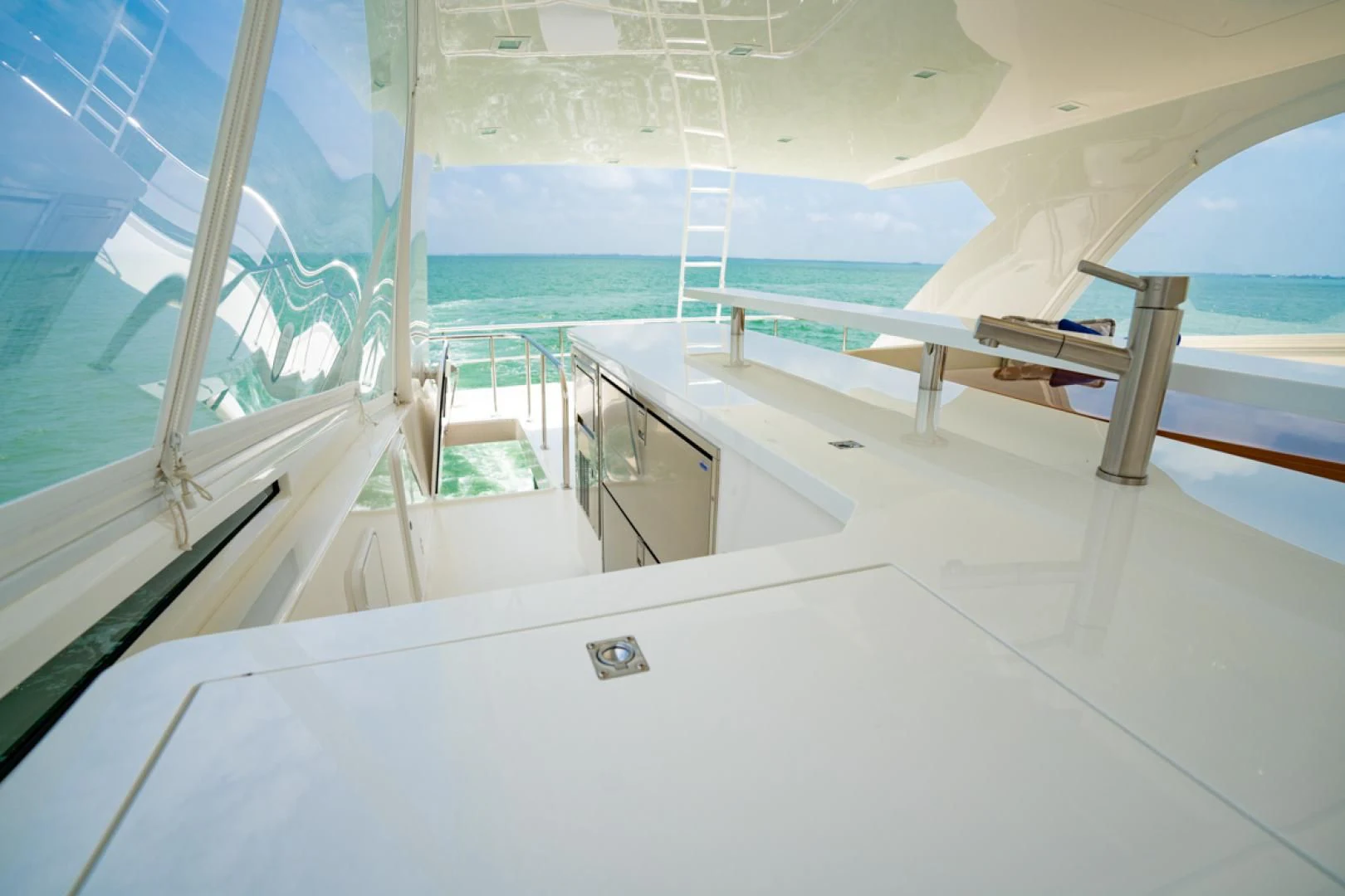 a room with a glass wall and a pool aboard MAKE IT HAPPEN Yacht for Sale