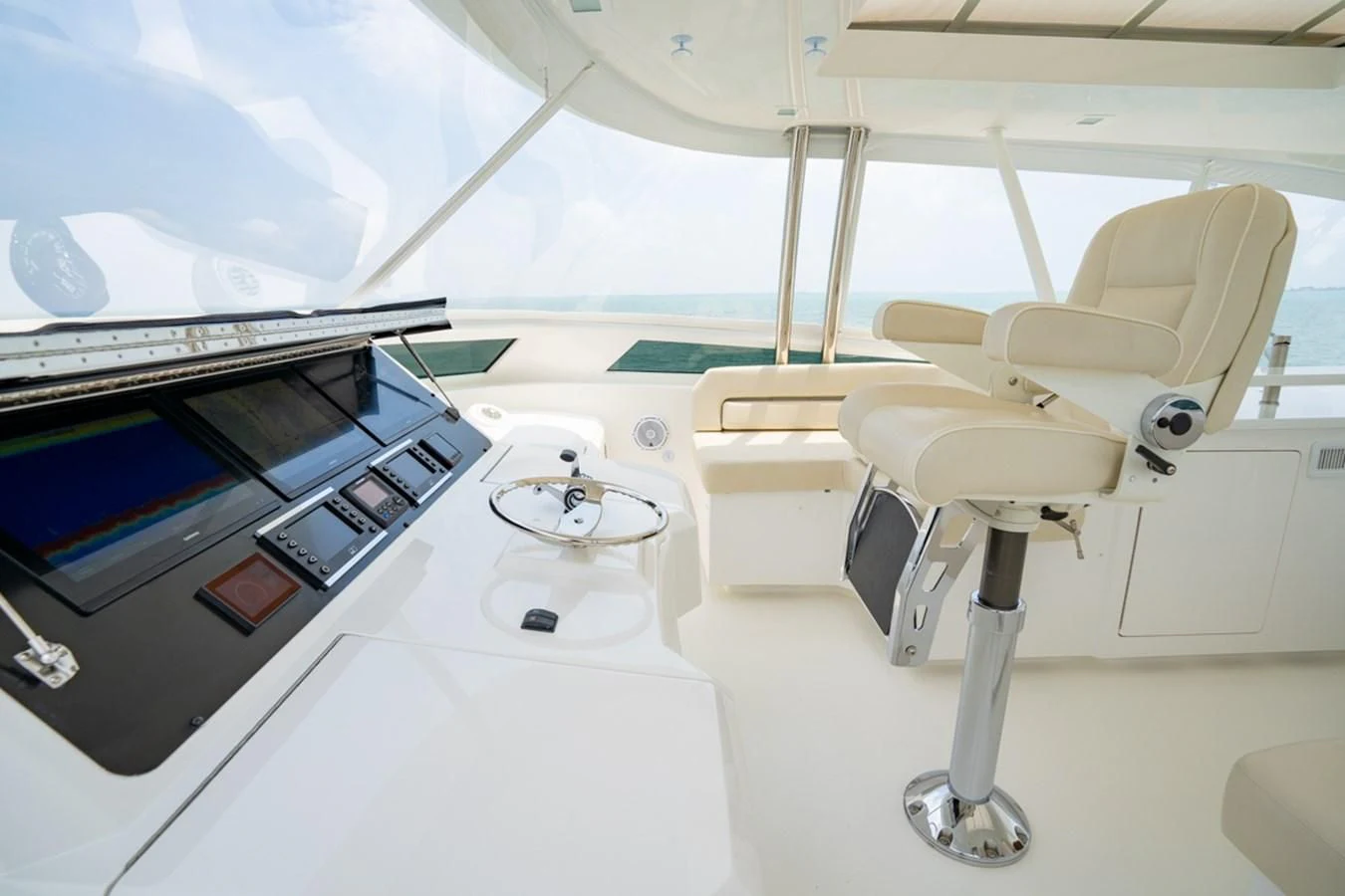 a white room with a table and chairs aboard MAKE IT HAPPEN Yacht for Sale