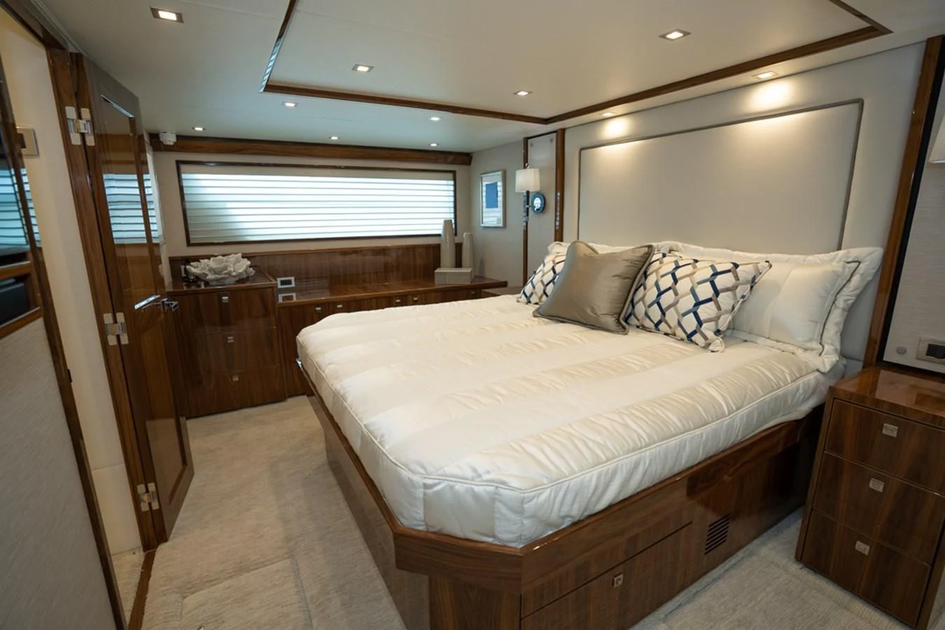 a bedroom with a bed and a dresser aboard MAKE IT HAPPEN Yacht for Sale