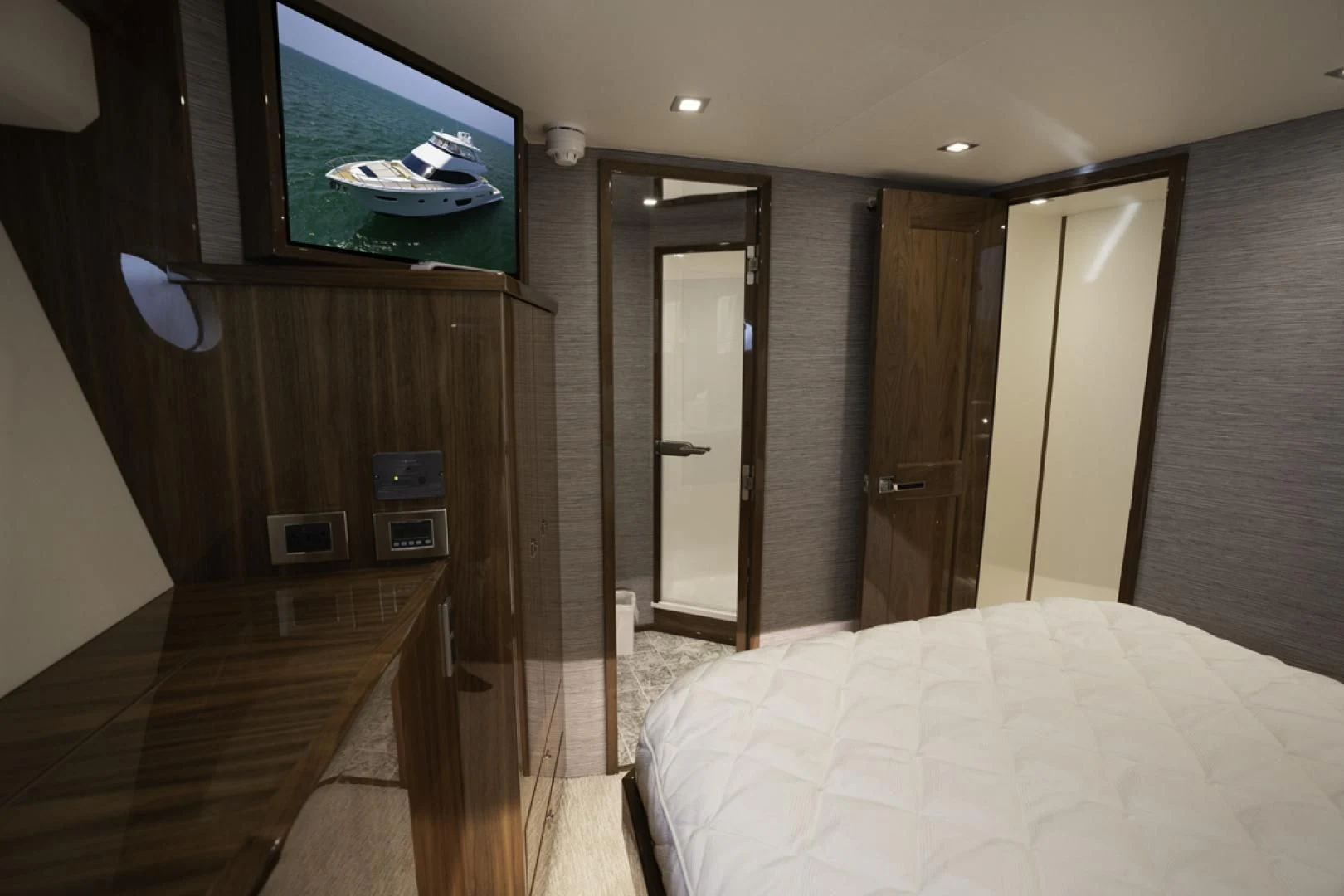 a bedroom with a bed and a television aboard MAKE IT HAPPEN Yacht for Sale