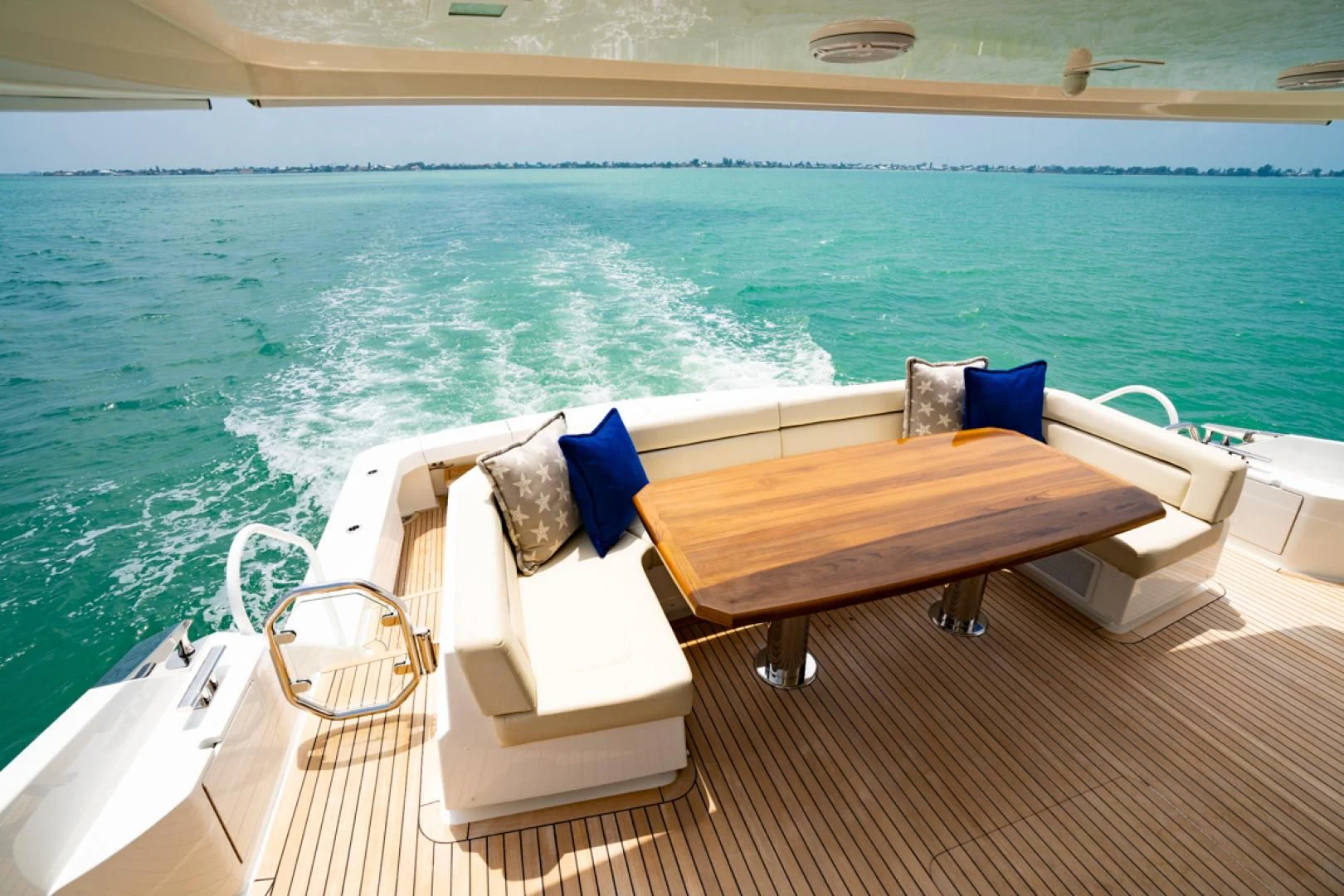 a lounge chair on a deck overlooking a body of water aboard MAKE IT HAPPEN Yacht for Sale