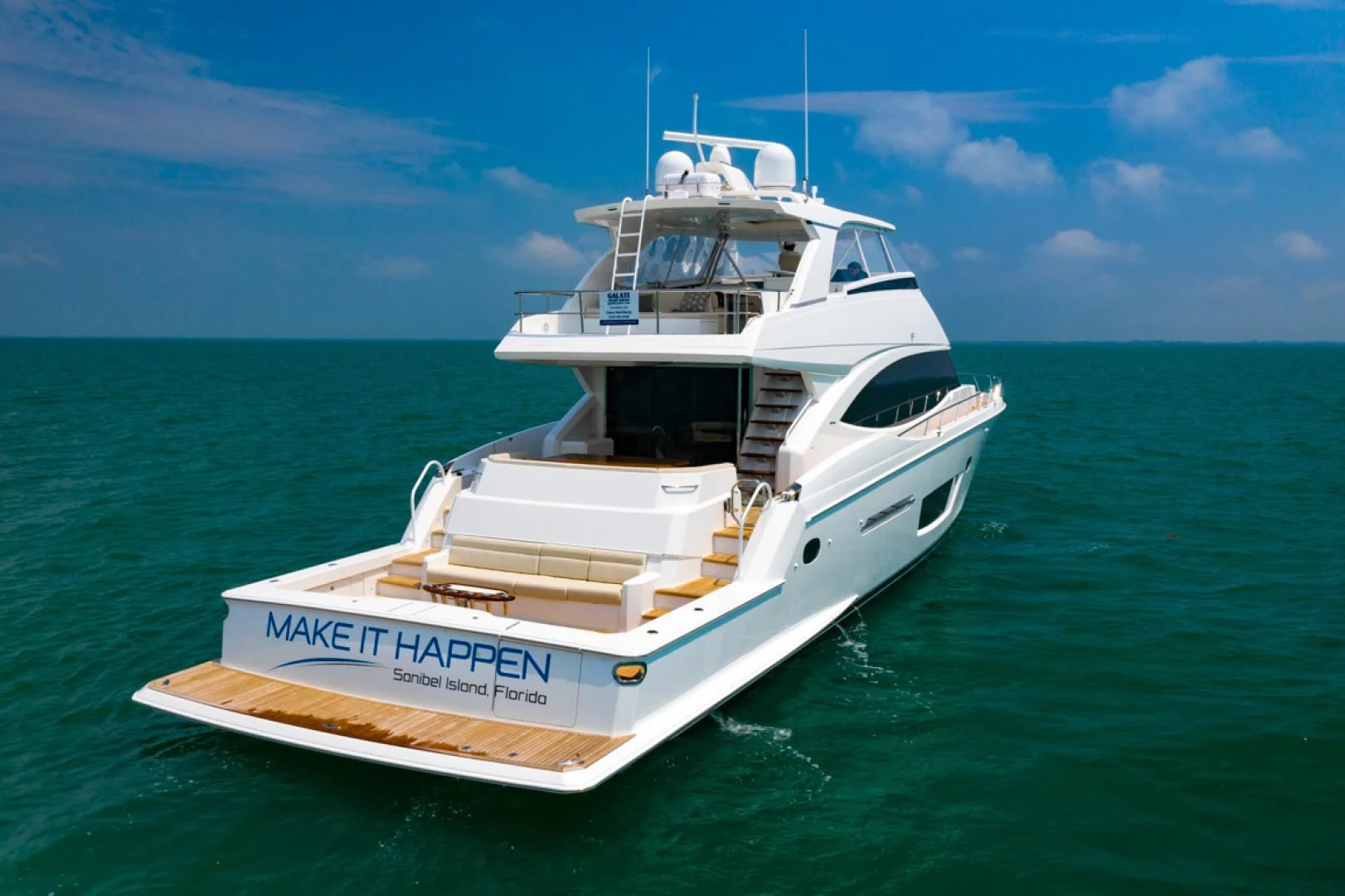 a white boat in the water aboard MAKE IT HAPPEN Yacht for Sale