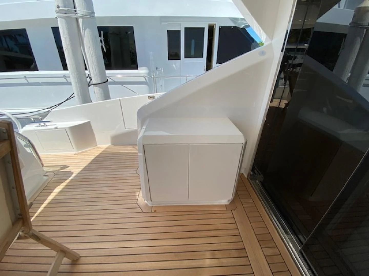 a room with a wood floor and a white cabinet with drawers aboard MAKE IT HAPPEN Yacht for Sale