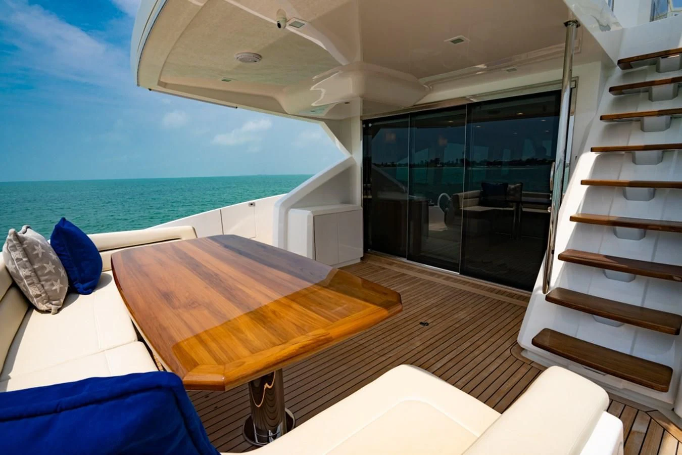 a room with a bed and a table and a view of the ocean aboard MAKE IT HAPPEN Yacht for Sale