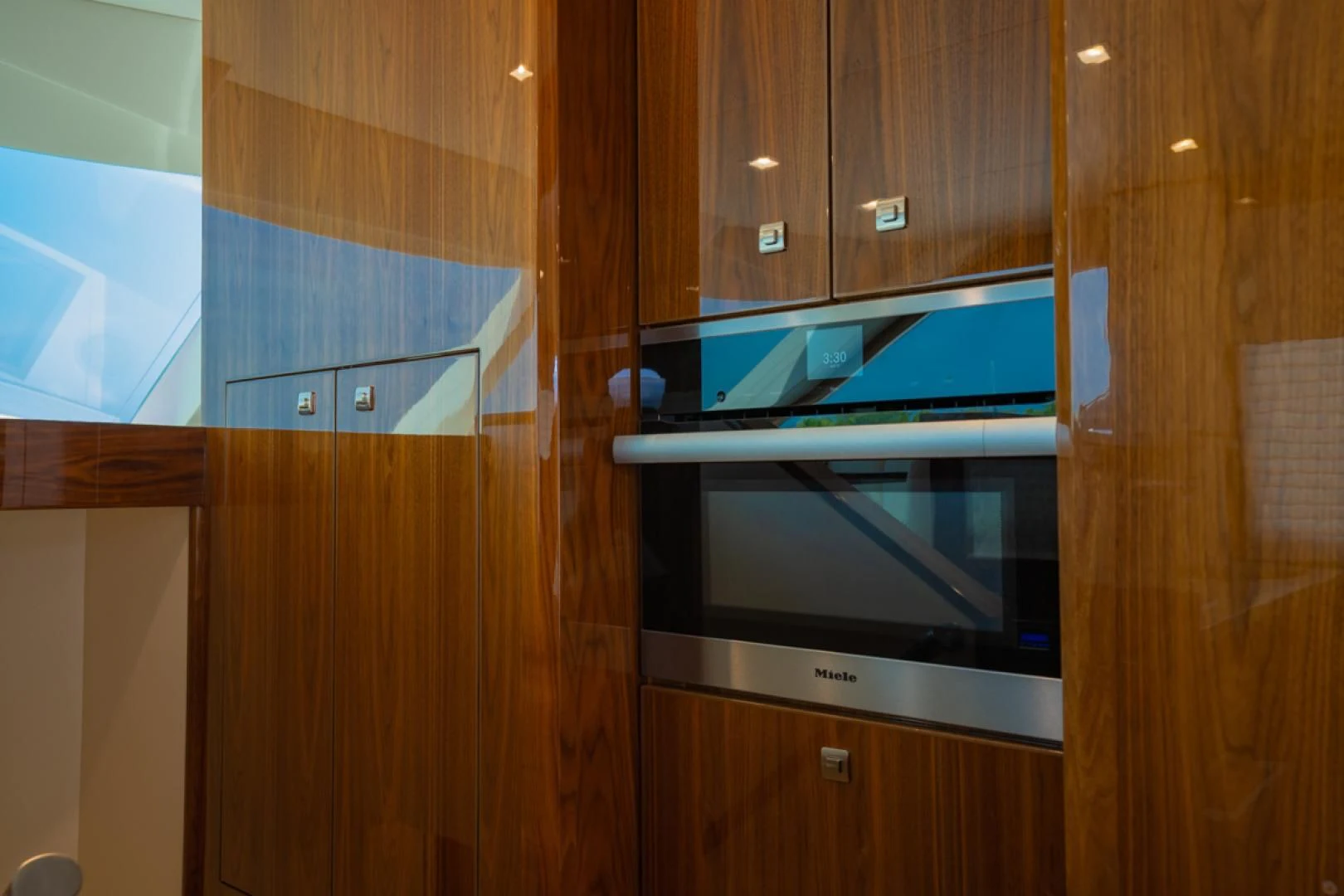 a microwave oven in a wooden cabinet aboard MAKE IT HAPPEN Yacht for Sale