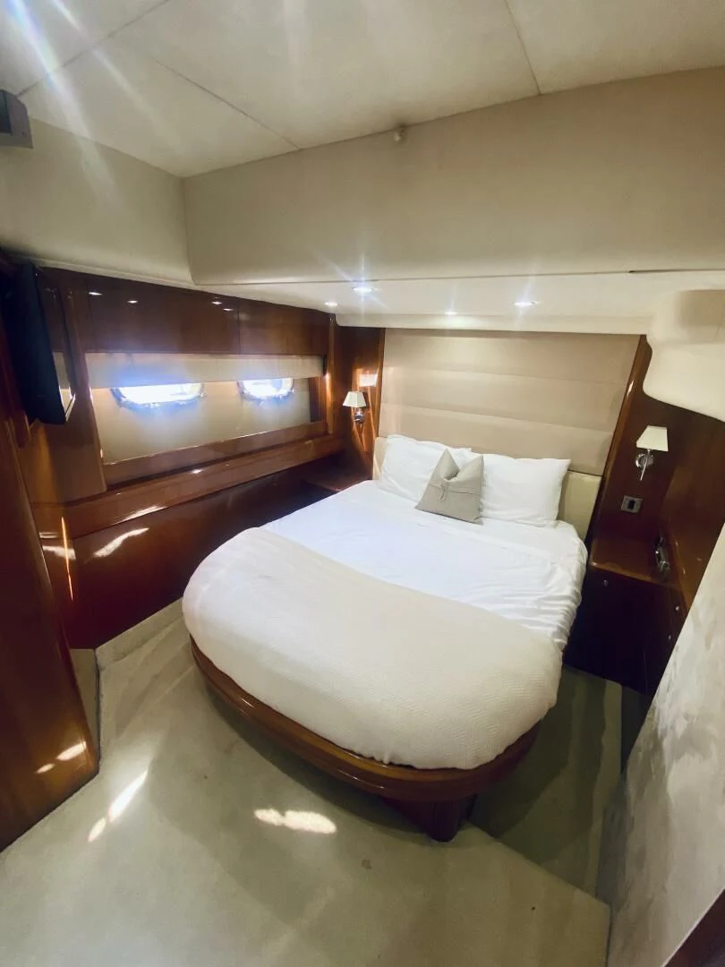 a room with a bed and a mirror aboard GRAND CRU Yacht for Sale