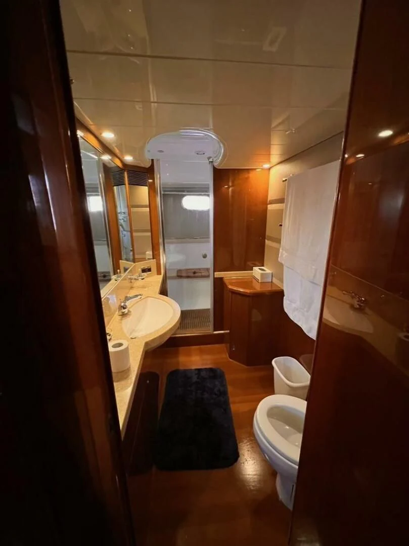 a bathroom with a blue rug aboard GRAND CRU Yacht for Sale