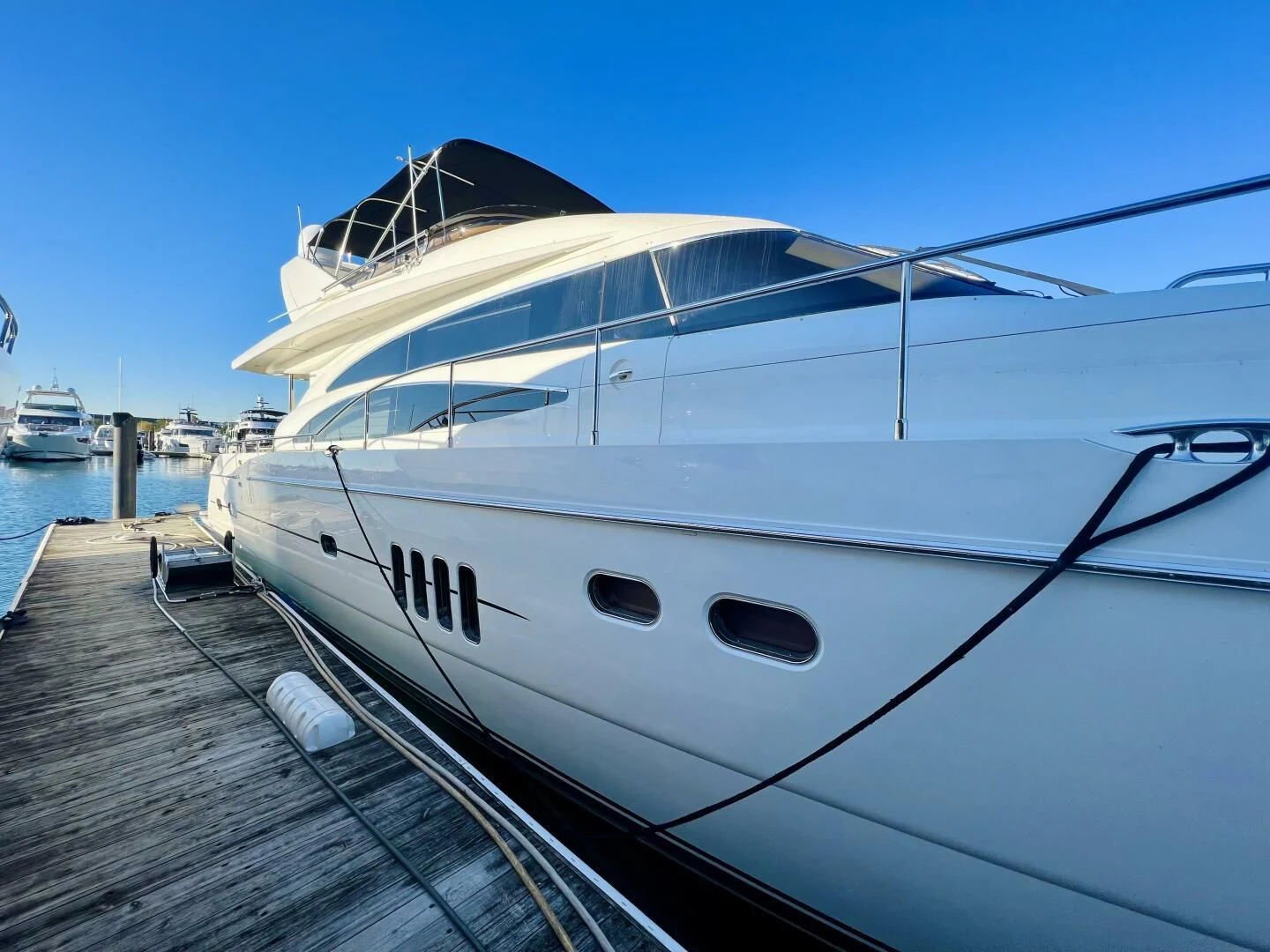 a large white yacht docked at a dock aboard GRAND CRU Yacht for Sale