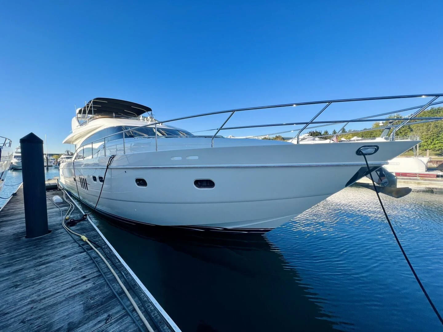 a white yacht docked at a dock aboard GRAND CRU Yacht for Sale