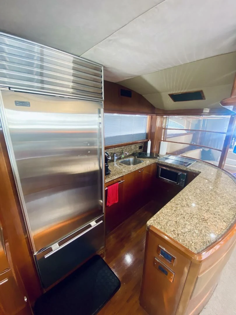 a kitchen with a stainless steel refrigerator aboard GRAND CRU Yacht for Sale