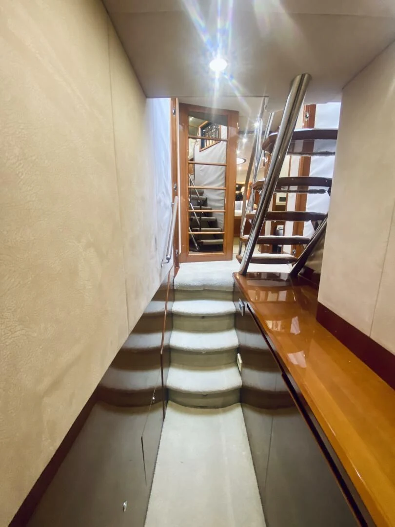 a hallway with a staircase and a staircase aboard GRAND CRU Yacht for Sale