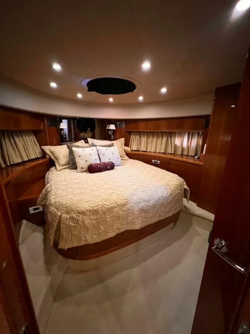 a bed with a white comforter aboard GRAND CRU Yacht for Sale