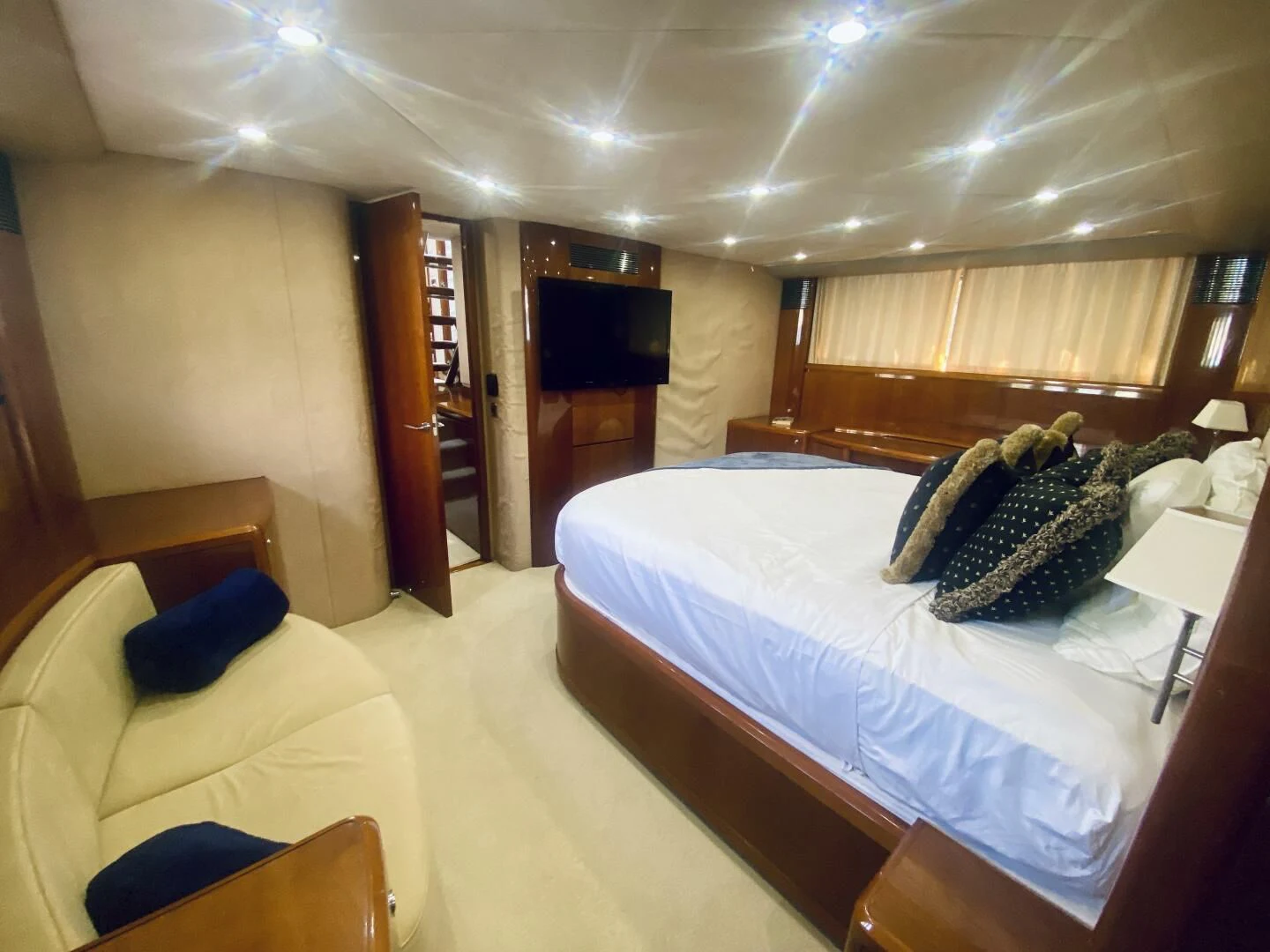 a room with a bed and a television aboard GRAND CRU Yacht for Sale