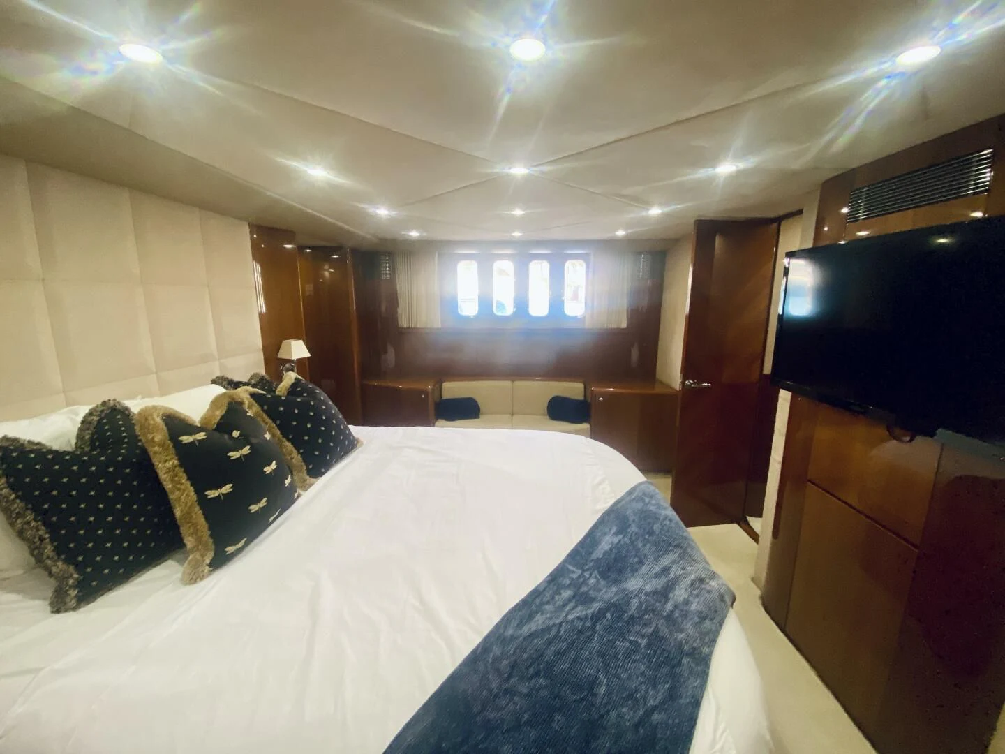 a room with a bed and a television aboard GRAND CRU Yacht for Sale