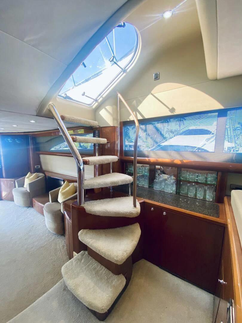 a room with chairs and a table aboard GRAND CRU Yacht for Sale