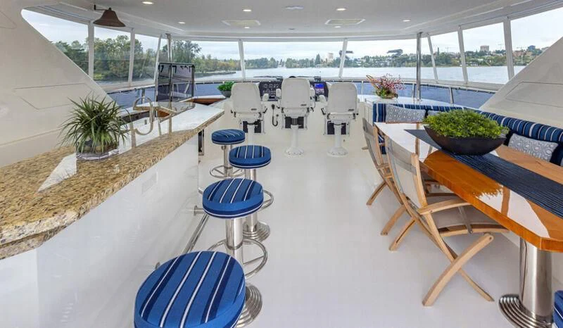 a room with tables and chairs aboard SPILL POINT Yacht for Sale