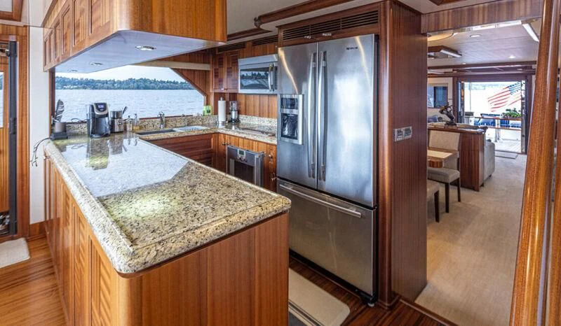 a kitchen with a stainless steel refrigerator aboard SPILL POINT Yacht for Sale