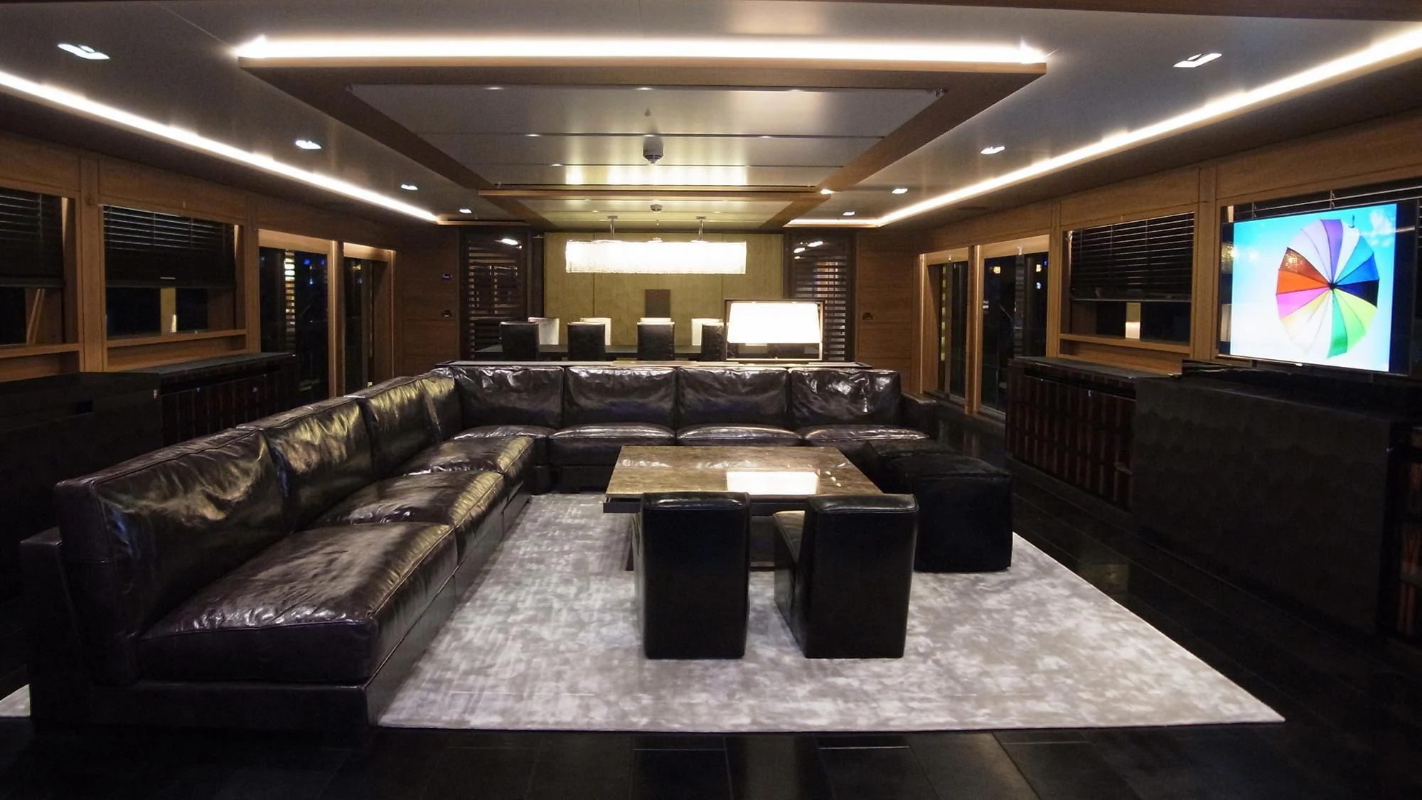 a large living room with a large screen aboard NAVIS ONE Yacht for Charter