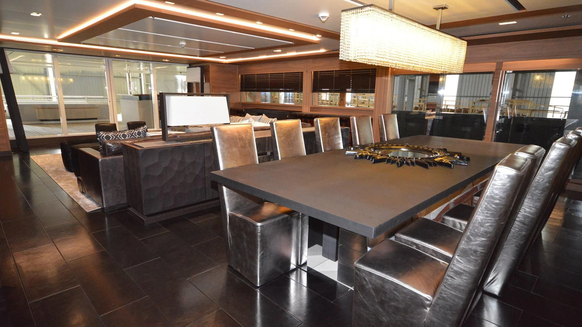 a room with a table and chairs aboard NAVIS ONE Yacht for Charter