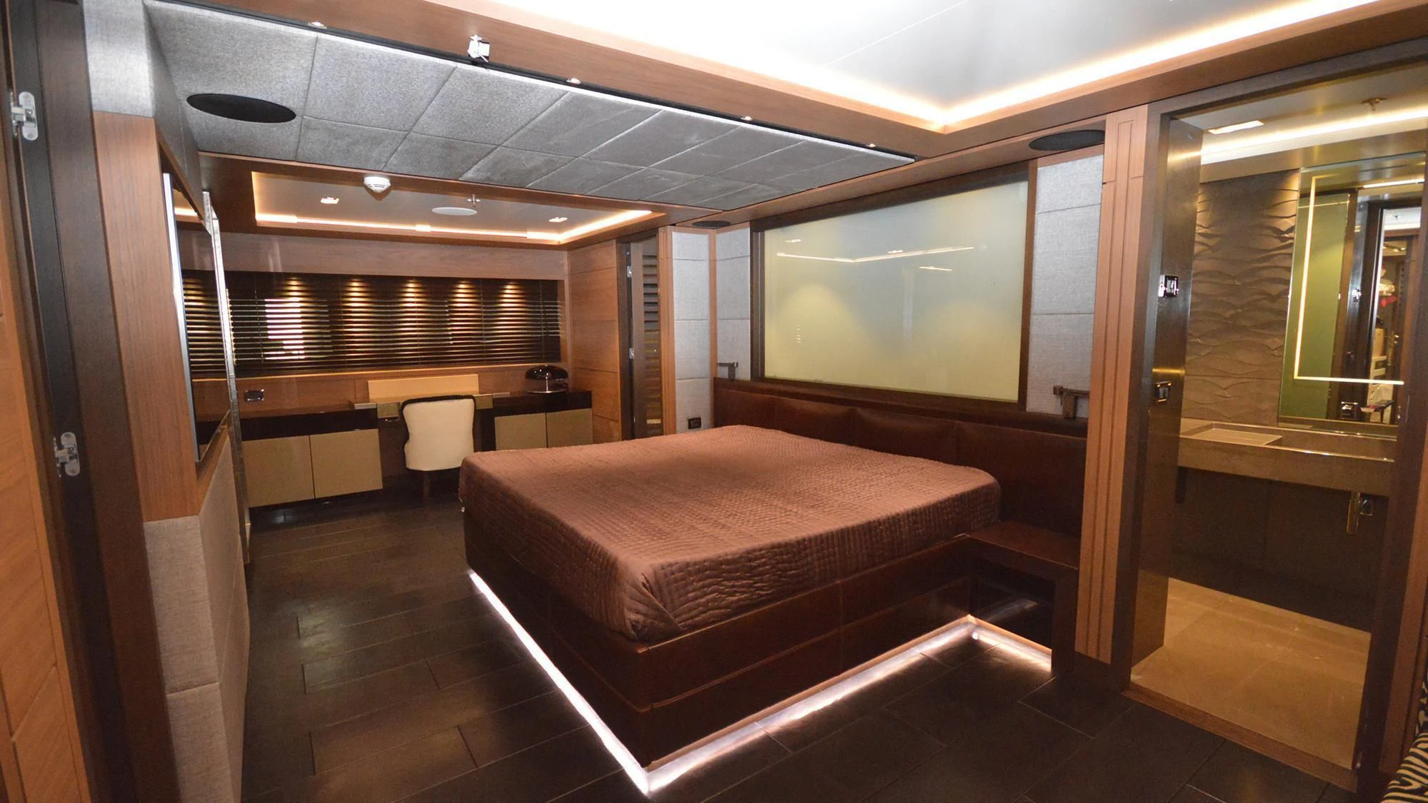 a room with a bed and a desk aboard NAVIS ONE Yacht for Charter