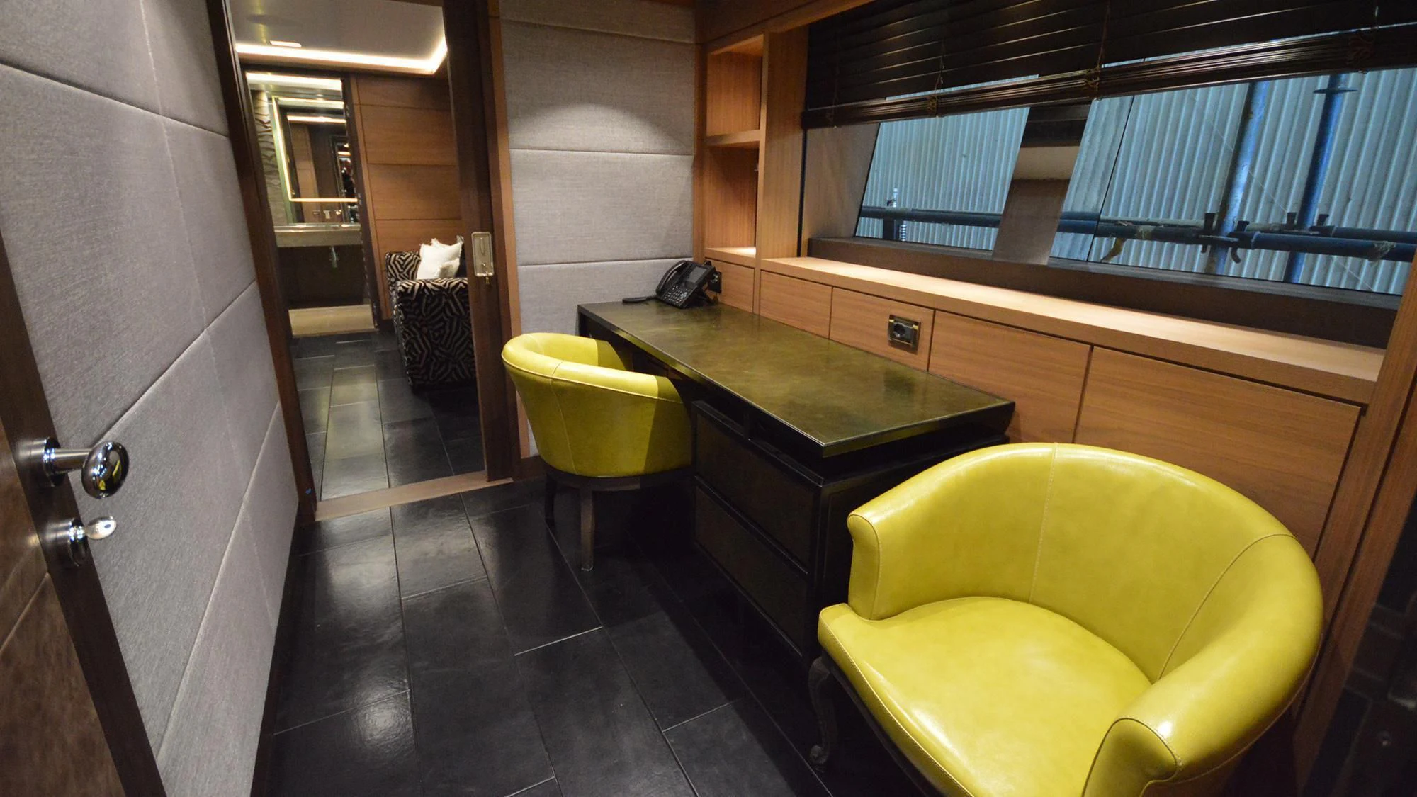 a room with a desk and chairs aboard NAVIS ONE Yacht for Charter