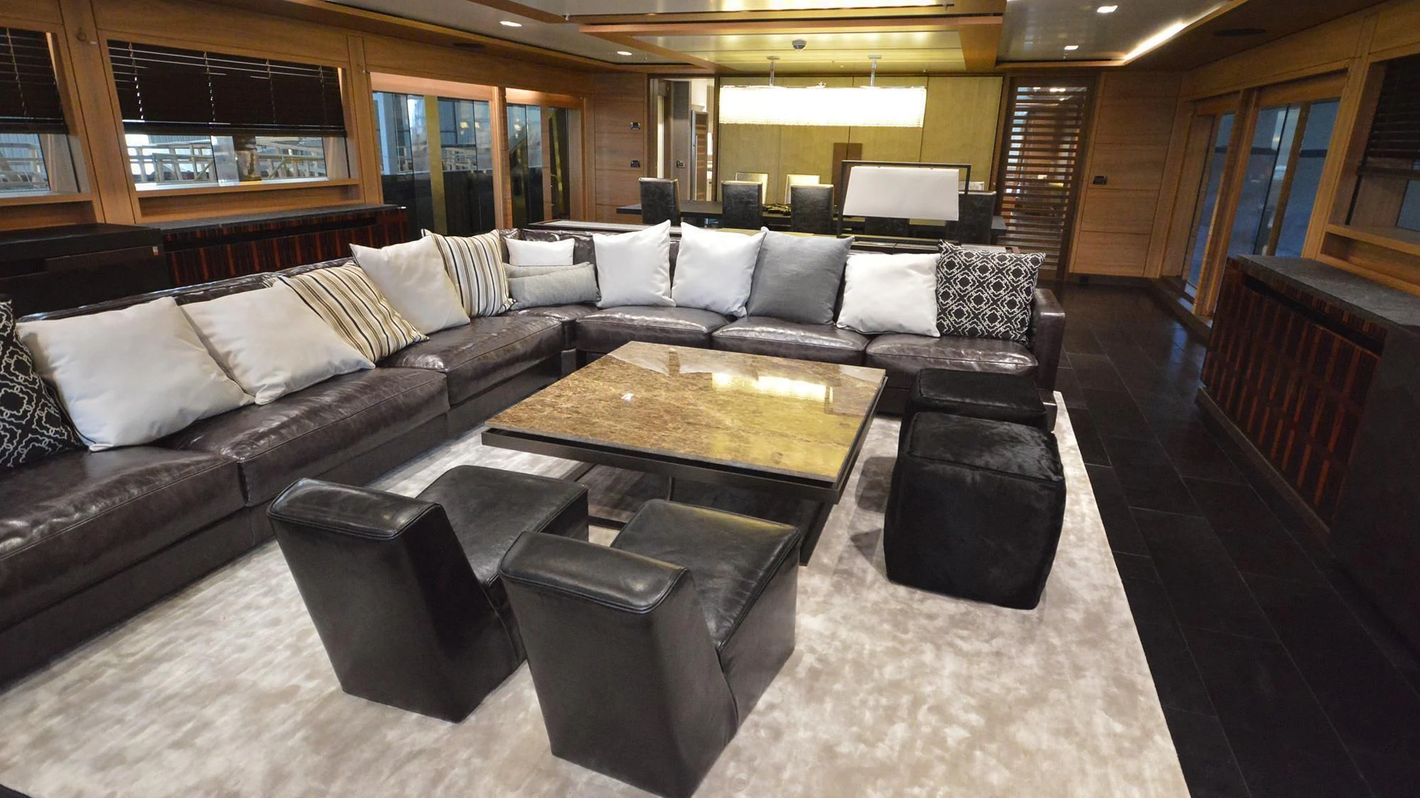 a large living room with leather couches and a coffee table aboard NAVIS ONE Yacht for Charter