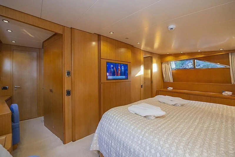 a room with a bed and a tv on the wall aboard LADY EMESA Yacht for Sale